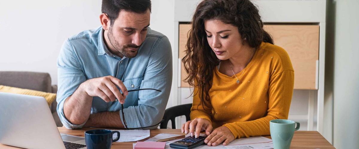 Young couple calculating their domestic bills at home stock photo