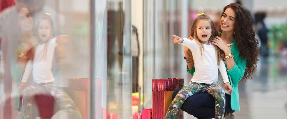 Young mother and her daughter doing shopping together