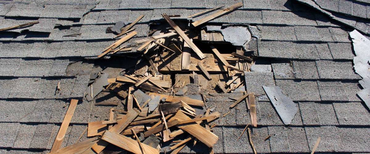 Roof construction site. Removal of old roof, replacement with new shingles, equipment and repair. Roofs are a very important part of all housing projects around the world.