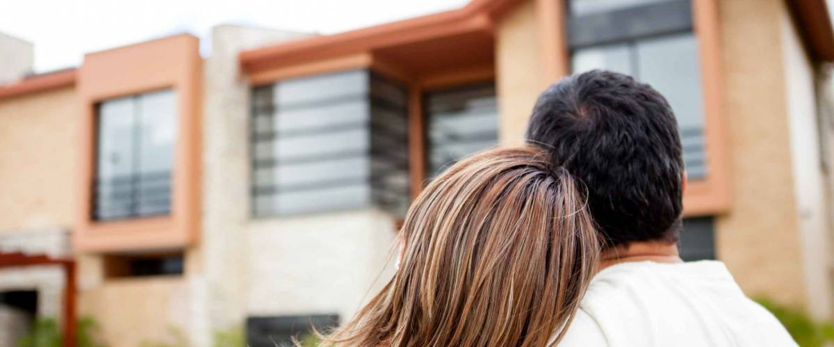 Loving couple looking at their dream house