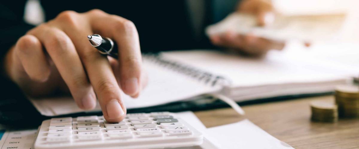 Close up of person's hand using calculator