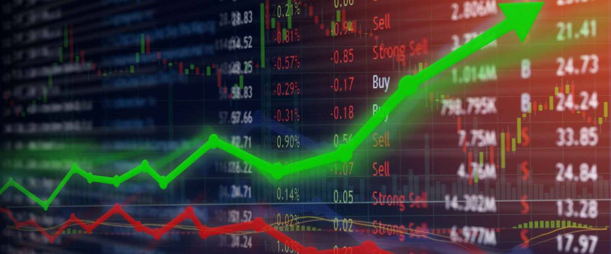 Investing and stock market concept gain and profits with faded candlestick charts.