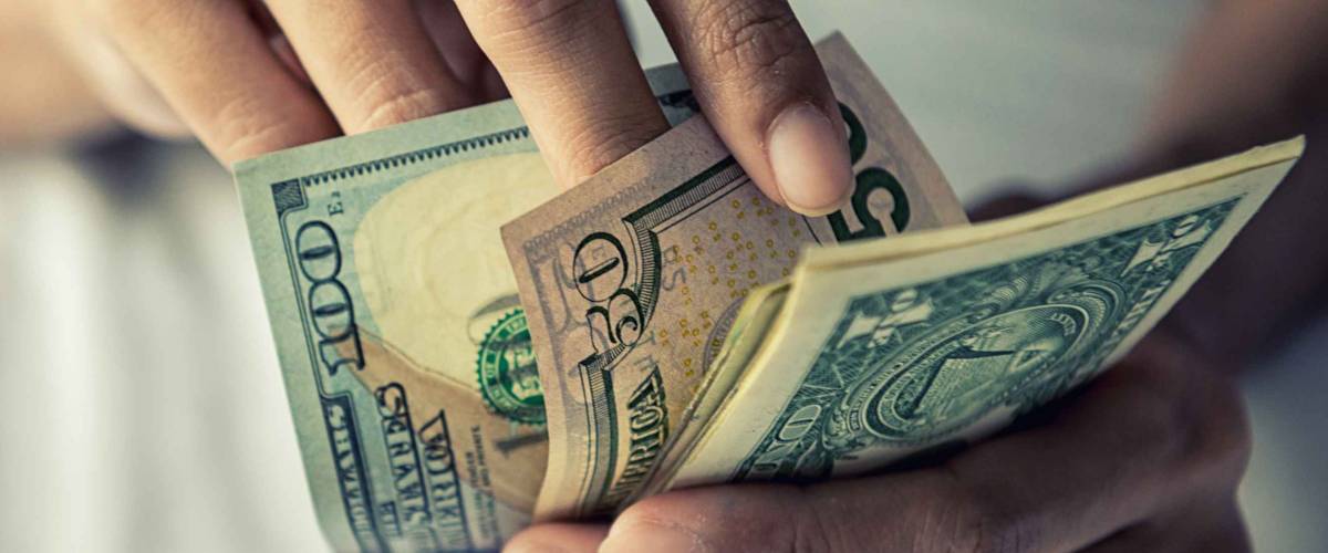 Close-up Hands counting money American dollars , Counting money American dollars with hand , Vintage tone effect , Income and Business concept.