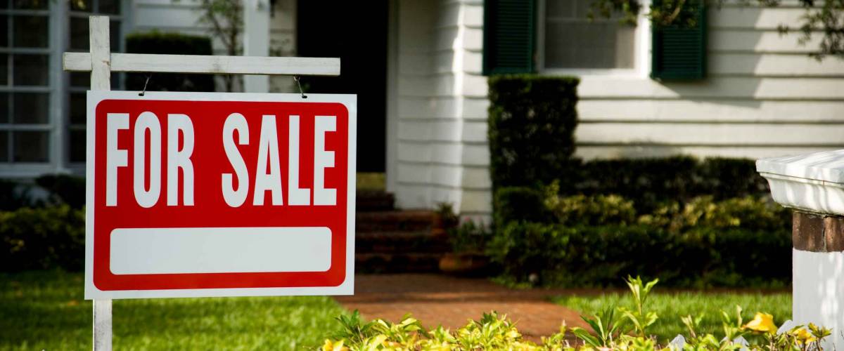 For sale sign outside a family house