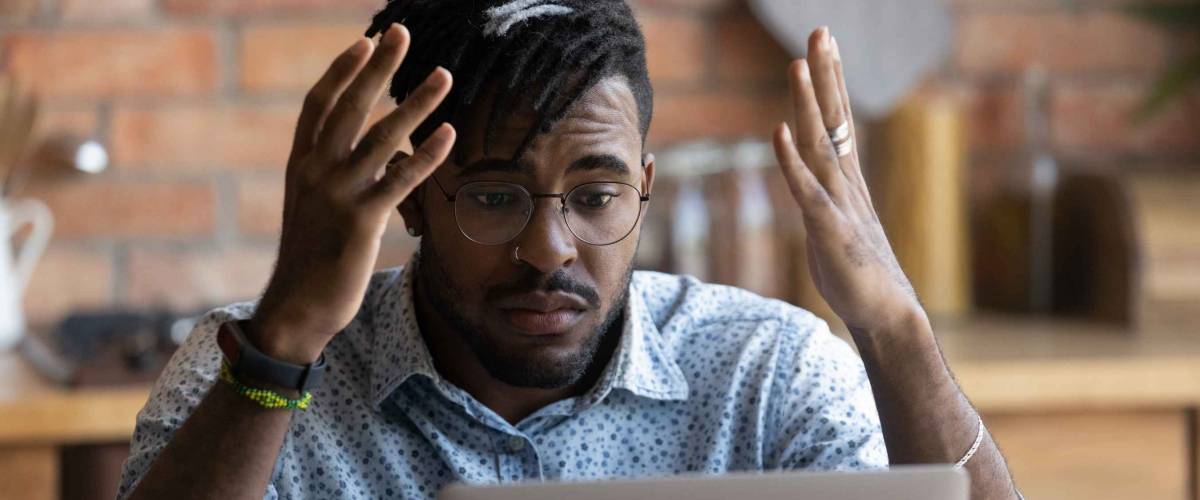 man looking at computer screen, stressed