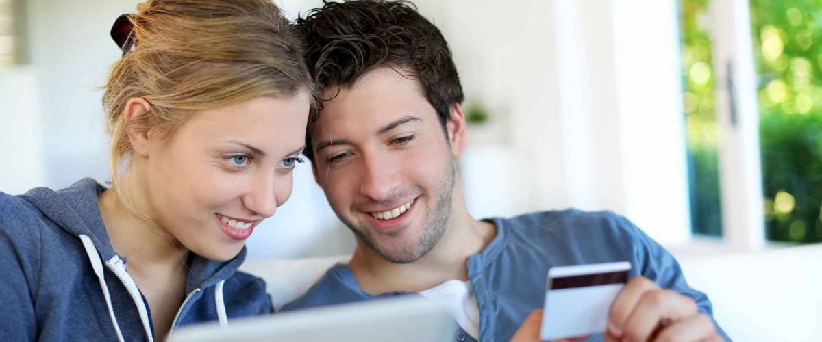 Happy young couple doing shopping on internet
