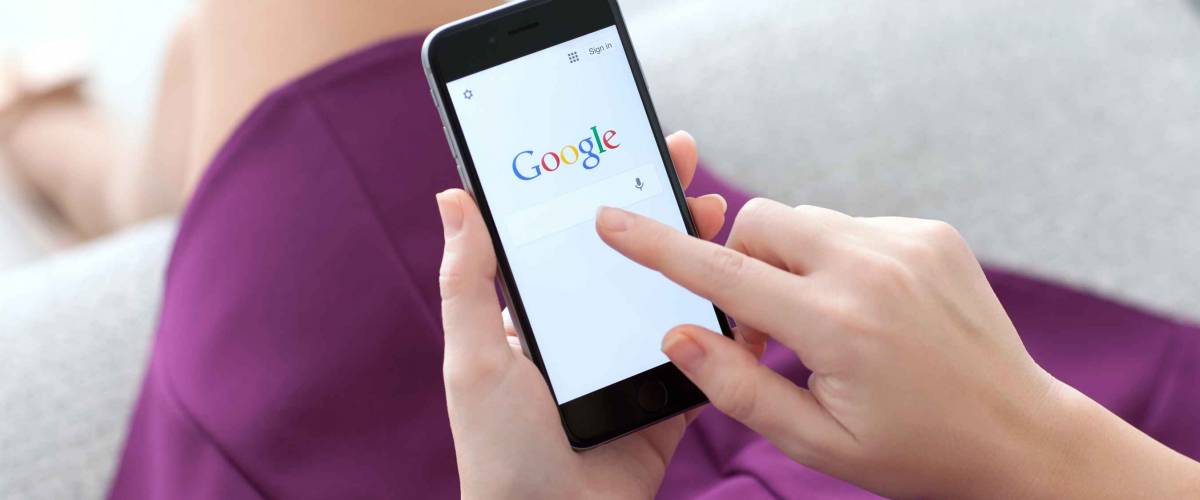 Alushta, Russia - November 22, 2014: Woman holding a iPhone 6 Space Gray with social networking service Google on the screen. iPhone 6 was created and developed by the Apple inc.