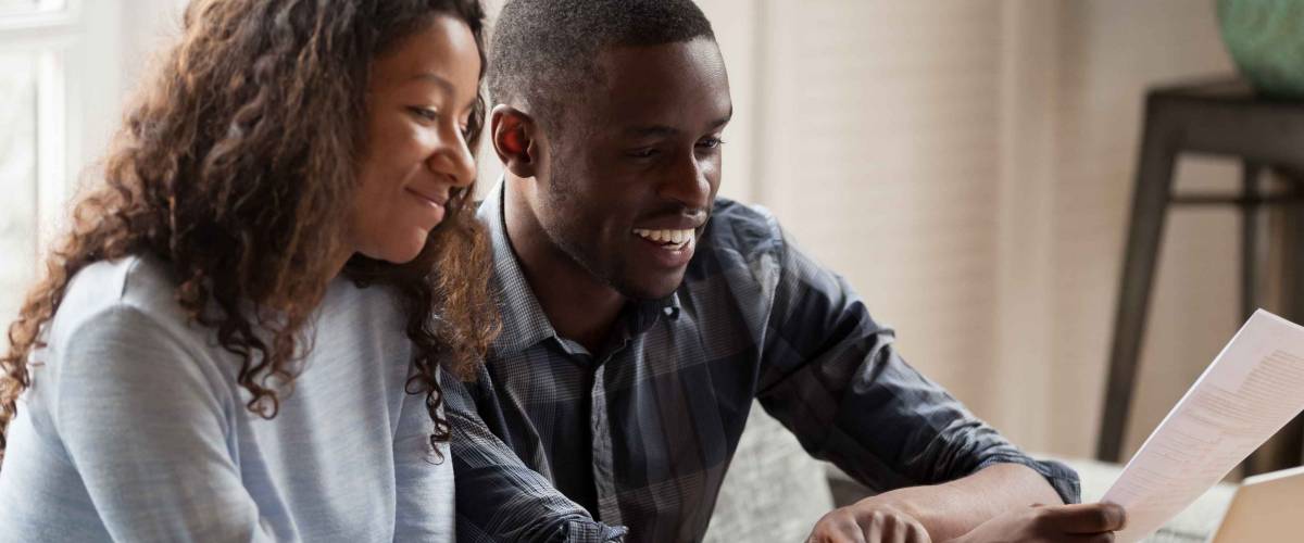 Happy couple financial bills, pay online on computer, smiling
