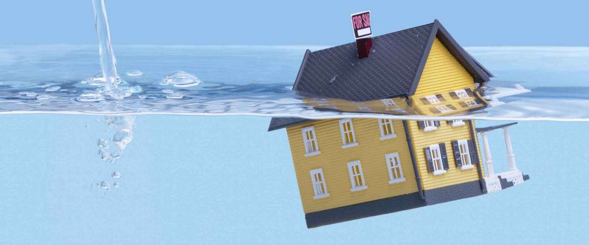 Underwater home mortgage, house for sale, real estate crisis concept, copy space