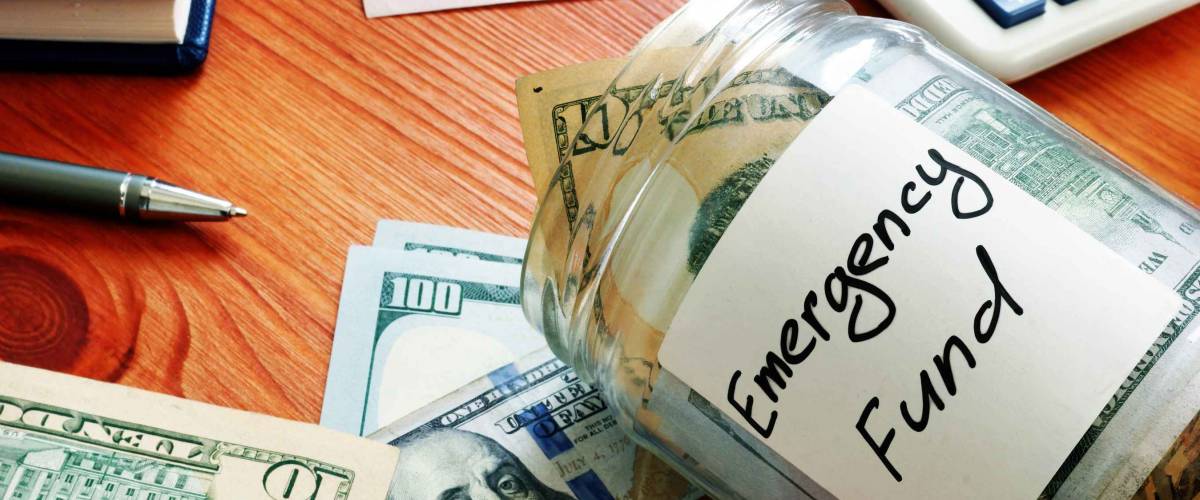 Emergency fund in the glass jar with cash.