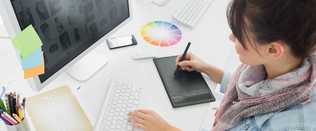 High angle view of an artist drawing something on graphic tablet at the office
