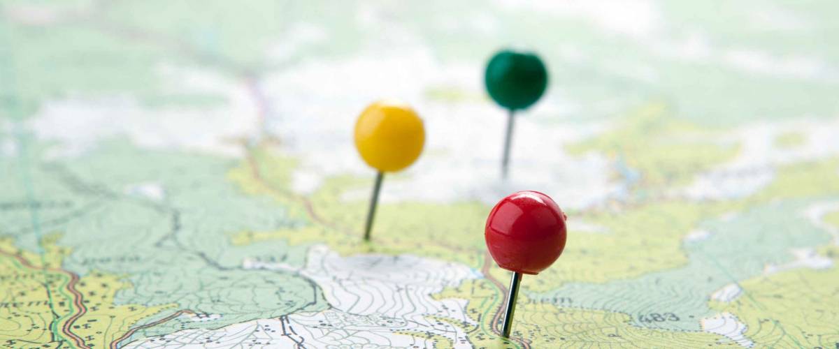 topographic map with colored needles pushpins