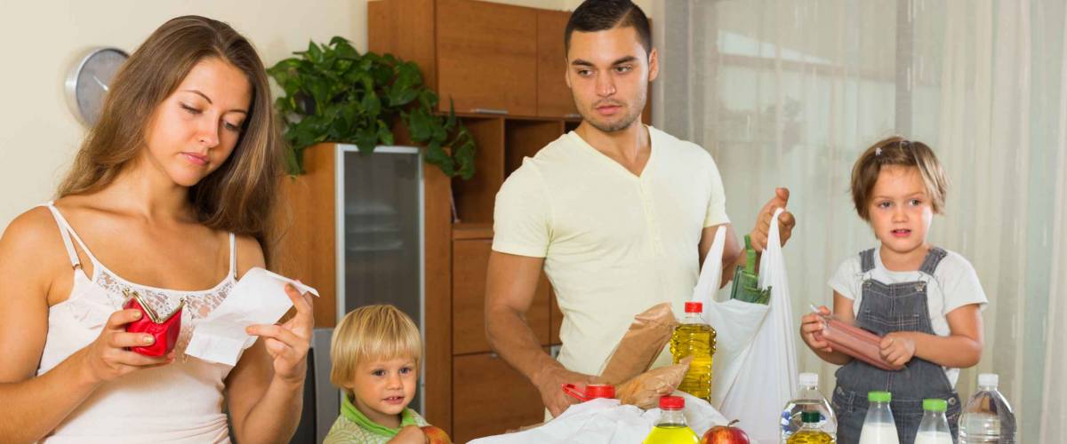 Sad woman with receipt from store, family brought food home. Focus on woman