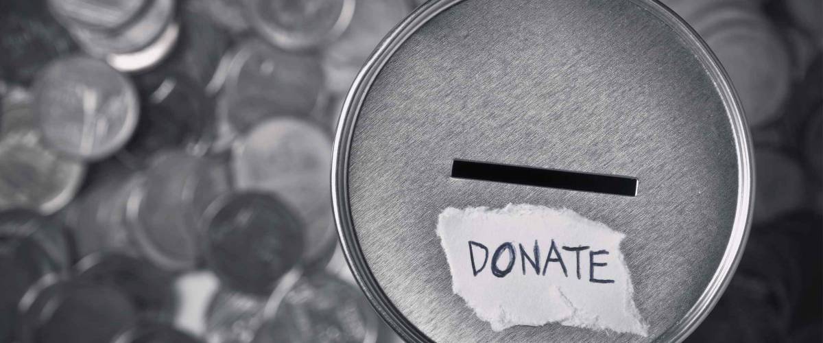 top view of donation box for charity with money coins in black and white.