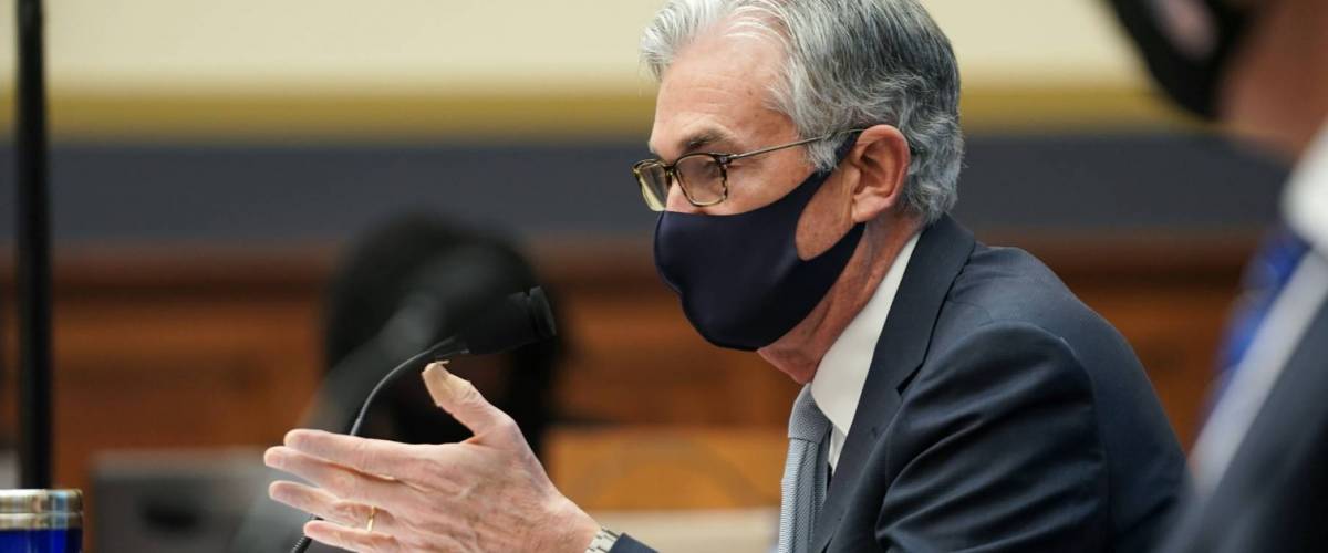Federal Reserve Chairman Jerome Powell speaks at meeting wearing a face mask