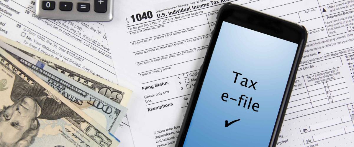 e-file taxes with mobile phone on 1040 form with cash in corner