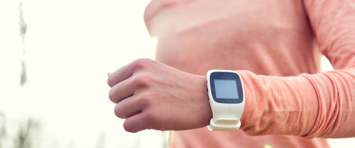 Heart rate monitor smart watch for sport. Athlete wearing heart rate monitor. Runner using sports smartwatch