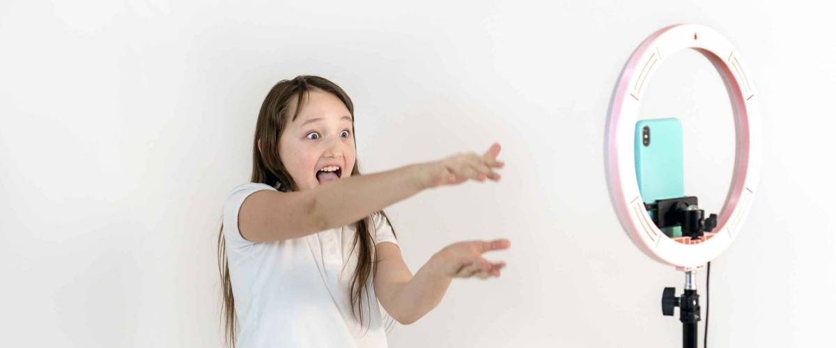 A teenage girl dances and shoots a video