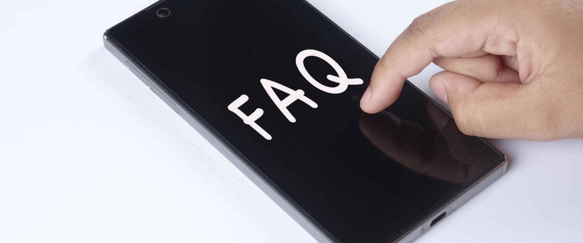 hand of child is holding a modern smartphone with FAQ text