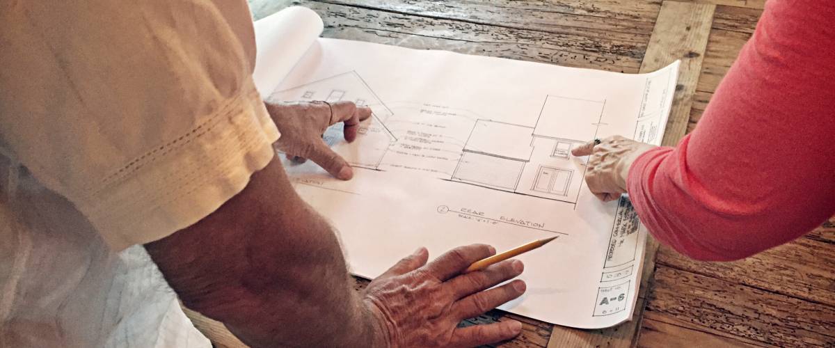 An architect discusses blueprints.