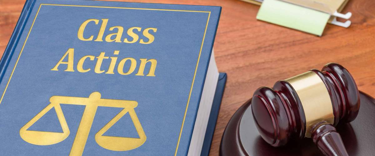 A law book with a gavel - Class action