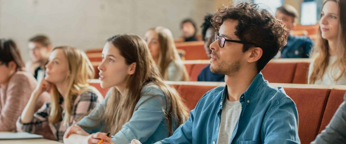 Young people in classroom setting, listening attentively