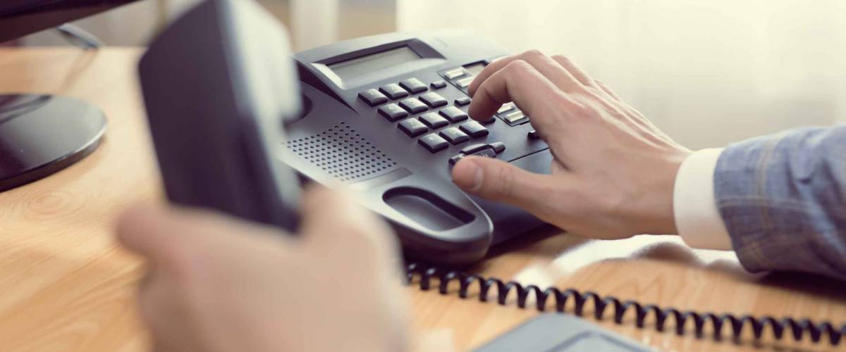 close up of man picking up phone, dialing