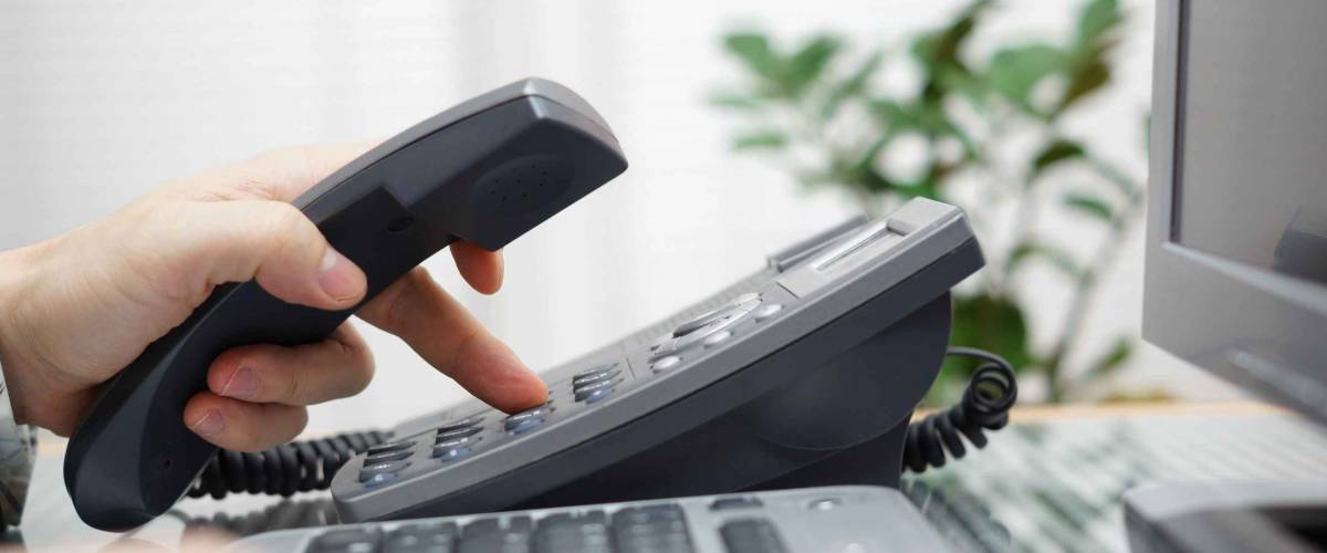 businessman is dialing a phone number in office