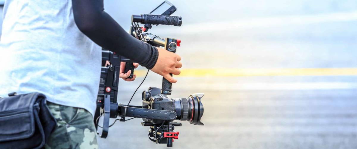 Videographer with gimbal video camera dslr, Professional video equipment, Videographer in event film production shoot video.