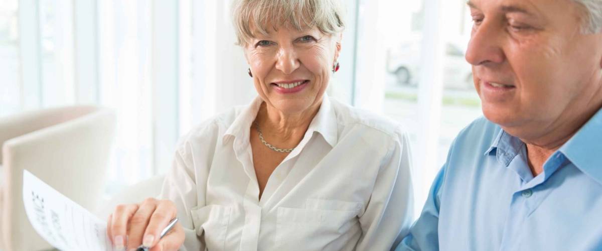 Senior couple read the form for life insurance