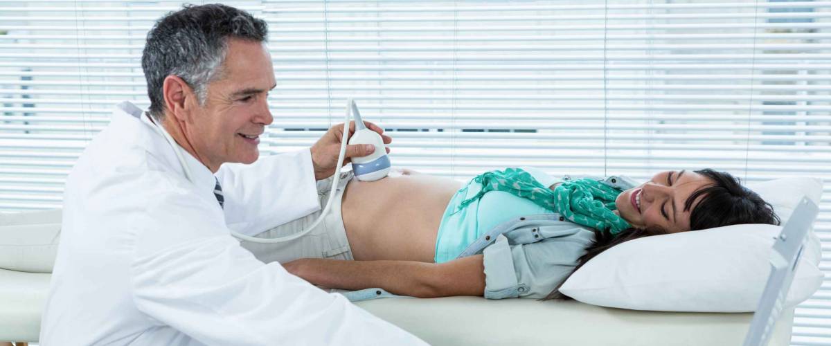 Pregnant woman undergoing ultrasound test in hospital