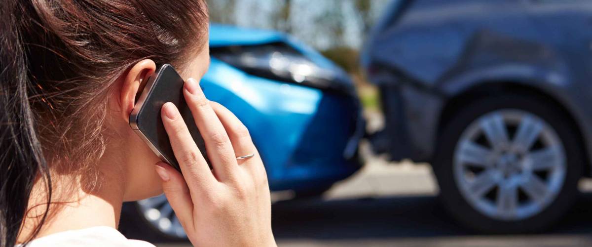 Stressed Driver Sitting At Roadside After Traffic Accident