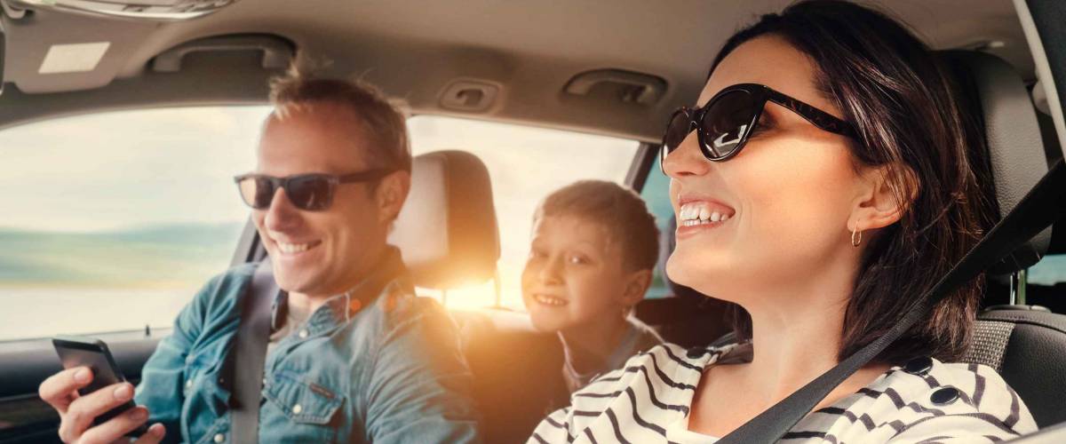 Happy family riding in a car
