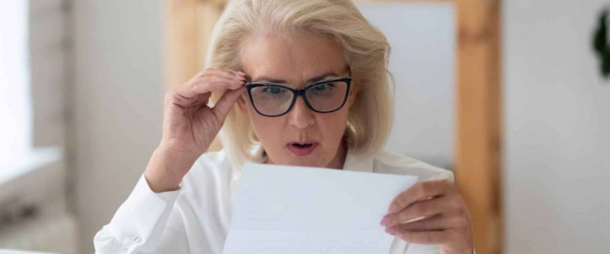 A woman looks with surprise at her low health insurance bill.
