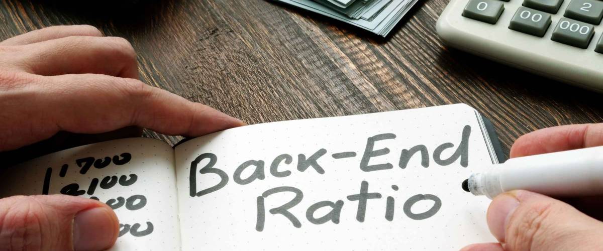 The man makes a note Back end ratio in a notebook.