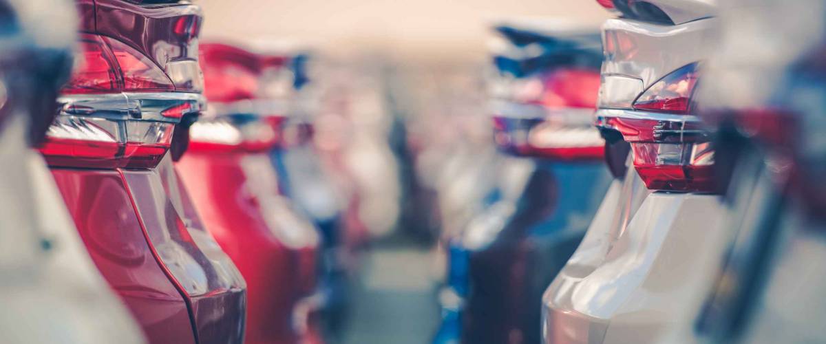 Rows of cars up close on a car dealership lot