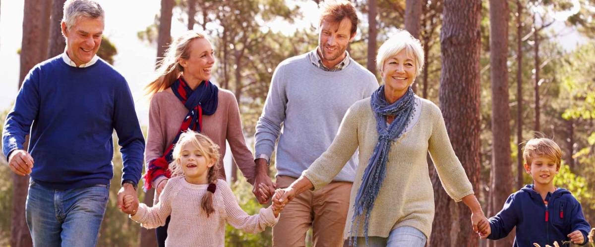 Happy multi-generation family walking in the countryside