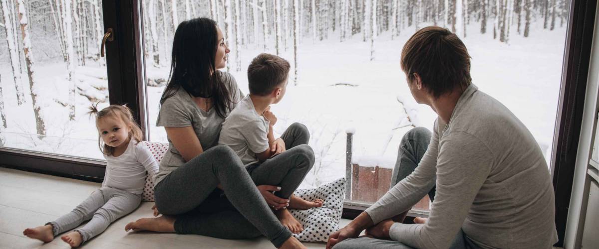 Family at home in pajamas. Daughter and son. Wake up in the morning. looking out the window.