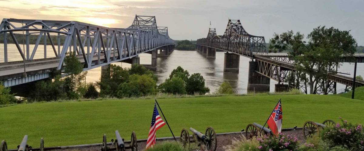 Two bridges crossing the Mississippi River contrasting old and new, railroad and highway, in Vicksburg, Mississippi