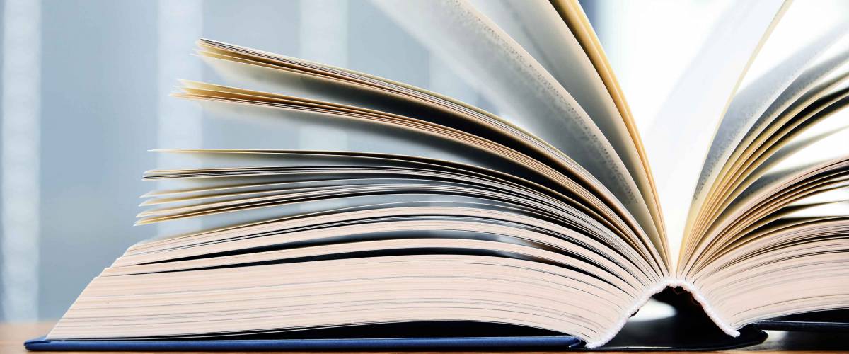 Hardcover book lying open on a table