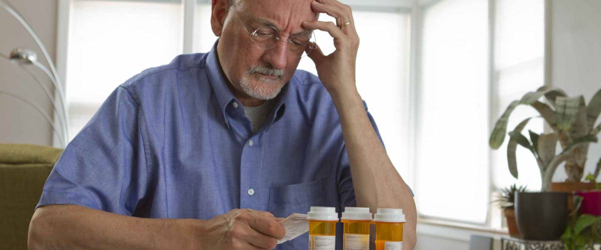 Older man with prescription medications.