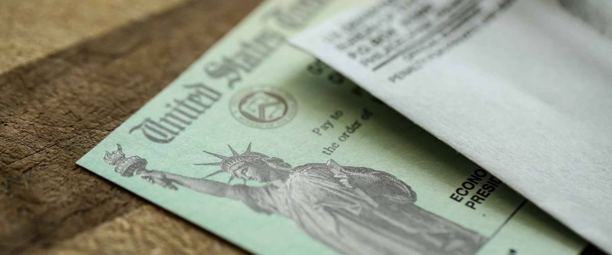 Extreme close-up of Federal coronavirus stimulus check provided to all Americans from the United States Treasury in 2020, showing the statue of liberty.
