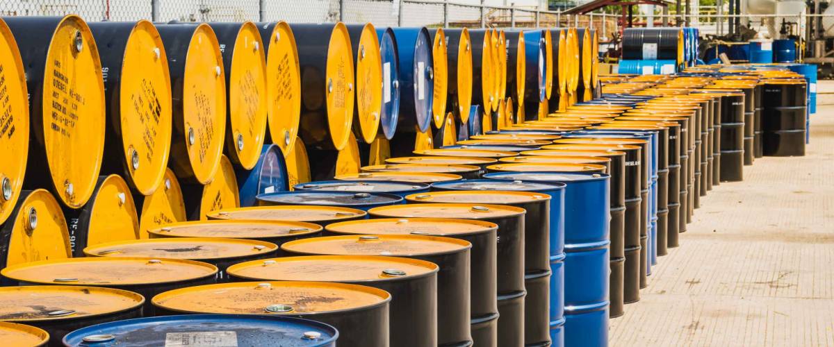Industry oil barrels or chemical drums stacked up.container of barrels of hydrocarbons.hazardous waste of black and blue tank oil.Stack Of Oil barrels in plant.