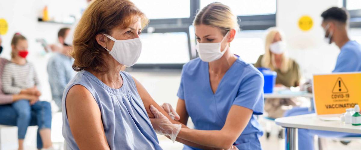 Woman with face mask getting vaccinated, coronavirus, covid-19 and vaccination concept.
