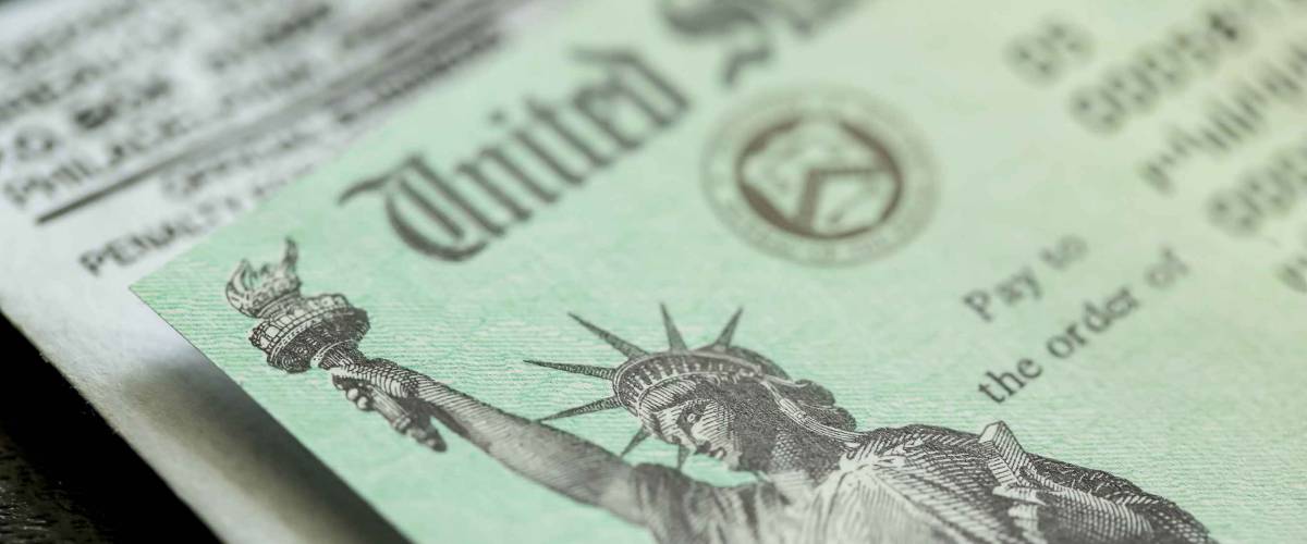 Extreme close-up of Federal coronavirus stimulus check provided to all Americans from the United States Treasury in 2020, showing the statue of liberty.