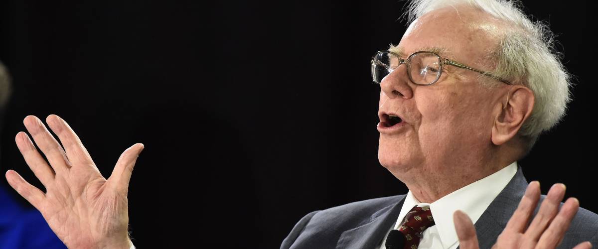 Warren Buffett speaks with hands up