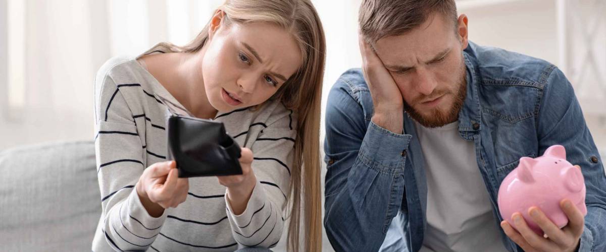 No money left. Stressed millennial couple counting last money at home