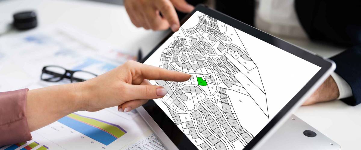 People Using Cadastral Survey Map On Tablet Screen