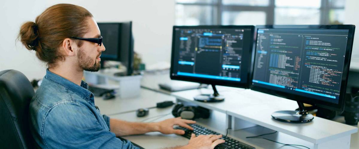 Programming. Man Working On Computer In IT Office, Sitting At Desk Writing Codes. Programmer Typing Data Code, Working On Project In Software Development Company. High Quality Image.