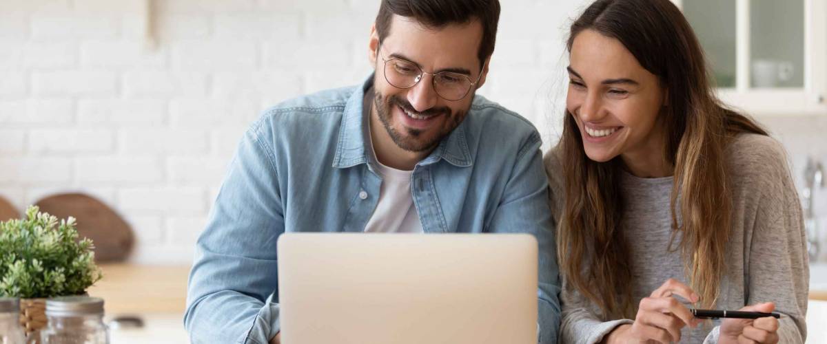 Happy young couple planning budget.